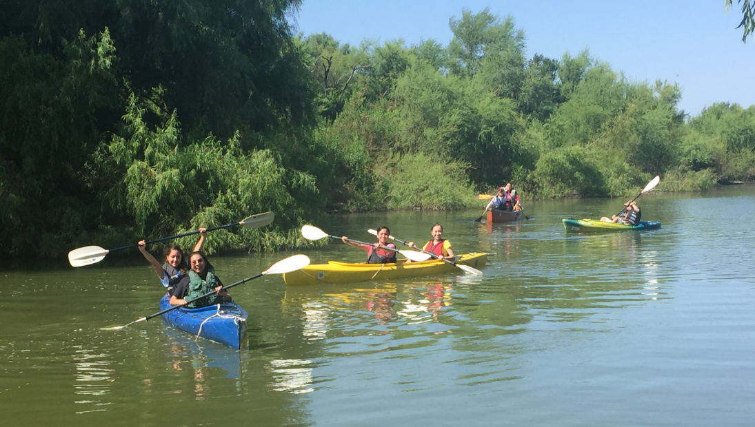 Students Kayaking in the University's Pond